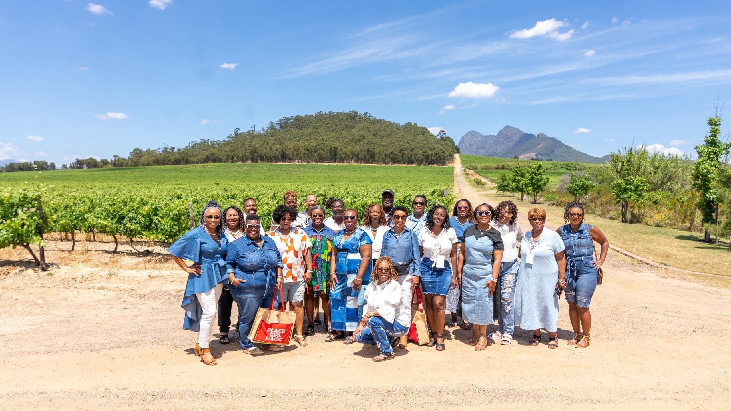 Travel Divas in front of a vineyard in South African wine county